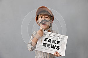 Newsboy shouting against grunge wall background. Boy selling fake news