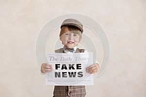 Newsboy shouting against grunge wall background. Boy selling fake news