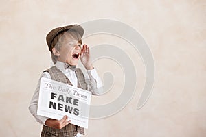 Newsboy shouting against grunge wall background. Boy selling fake news