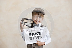 Newsboy shouting against grunge wall background. Boy selling fake news