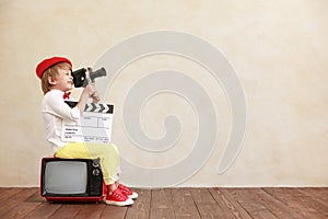 Newsboy shouting against grunge wall background. Boy selling fake news