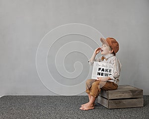 Newsboy shouting against grunge wall background. Boy selling fake news