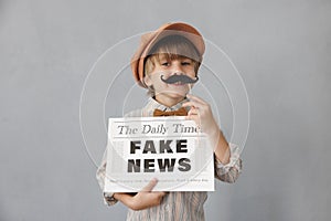 Newsboy shouting against grunge wall background. Boy selling fake news