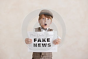 Newsboy shouting against grunge wall background. Boy selling fake news