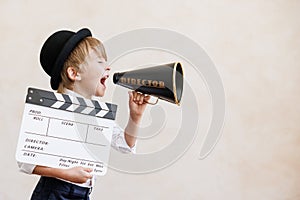 Newsboy shouting against grunge wall background. Boy selling fake news