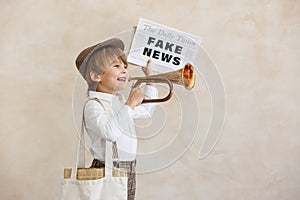 Newsboy shouting against grunge wall background. Boy selling fake news