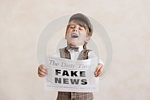 Newsboy shouting against grunge wall background. Boy selling fake news