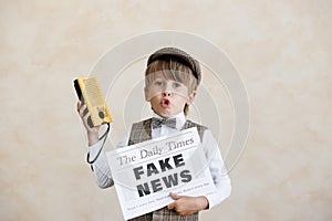 Newsboy shouting against grunge wall background. Boy selling fake news