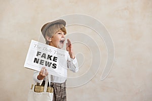 Newsboy shouting against grunge wall background. Boy selling fake news