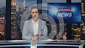 Newscaster ending late night news on tv. Female anchor leaving evening studio