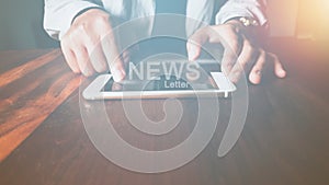 Newsletter concept Hand of businessman checking message box on mobile phone with Vintage tone filter