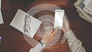 Newsletter concept  Hand of businessman checking message box to mobile phone with glasses and note book on table