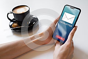 Newsletter subscription button on mobile phone screen. Business marketing concept.