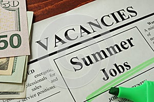 Newspaper with ads summer jobs vacancy.