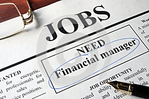 Newspaper with ads for vacancy financial manager.