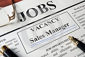 Newspaper with ads for vacancy sales manager.