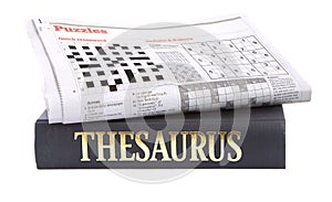 Newspaper crossword on top of a thesaurus photo