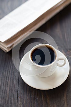 Newspaper and cup of coffee on table