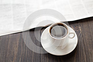 Newspaper and cup of coffee on table