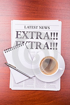 The newspaper EXTRA! EXTRA! and coffee