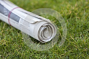 Newspaper on green grass outdoors background