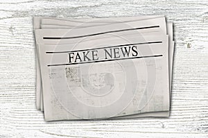 Newspaper with headline Fake News isolated on white background