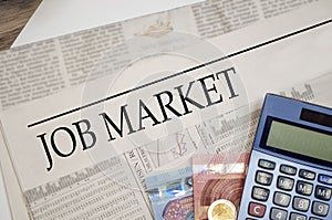 Newspaper with job market with money and calculator