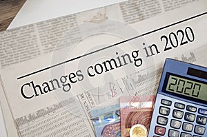 Newspaper with money and calculator and headline Changes coming in 2020