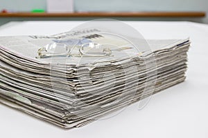 Newspaper Stack on white table