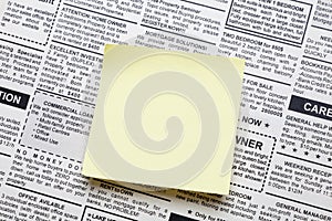 Newspaper and sticky note