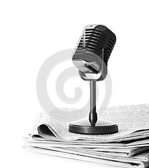Newspapers and vintage microphone isolated on white. Journalist`s work