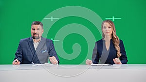 Newsroom TV Studio Live News Program: Caucasian Male and Female Presenters Reporting, Green Screen