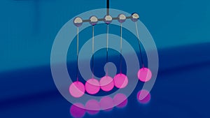 Newton Cradle or a desk toy pendulum, slow motion. Design. Close up of abstract balancing Newton balls creating relaxing