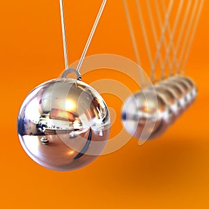 Newtons Cradle against an Orange Background photo