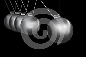 Newtons cradle silver balls on black background photo