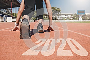 2020 Newyear , Athlete Woman starting on line for start running with number 2020 Start to new year photo