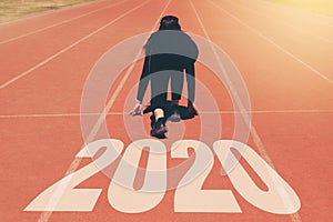 2020 Newyear , Athlete Woman starting on line for start running with number 2020 Start to new year