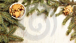 NewYear. Delicious ginger biscuits. Fir branch. Light background