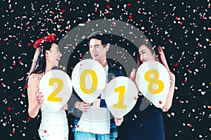Newyear party ,celebration party group of asian young people holding balloon numbers 2018 happy and funny concept