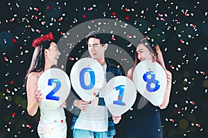 Newyear party ,celebration party group of asian young people holding balloon numbers 2018 happy and funny concept