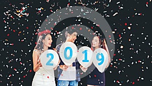 Newyear party ,celebration party group of asian young people holding balloon numbers 2019 happy and funny concept