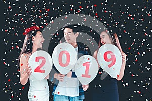 Newyear party ,celebration party group of asian young people holding balloon numbers 2019 happy and funny concept