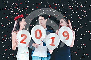 Newyear party ,celebration party group of asian young people holding balloon numbers 2019 happy and funny concept