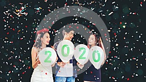 Newyear party ,celebration party group of asian young people holding balloon numbers 2019 happy and funny concept