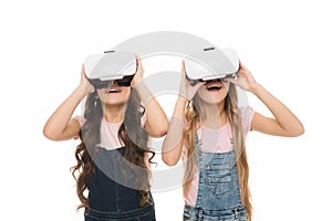 The next generation of virtual reality. Little girls wearing virtual reality headsets. Small children using virtual