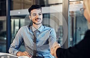 And so the next phase of the project begins. a young businessman and businesswoman shaking hands during a meeting in a