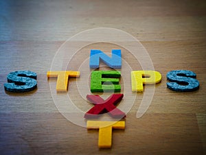 Next steps concept in colorful letters