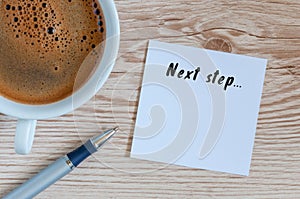 Next Steps inscription written in notepad near morning coffee cup. Business, technology, internet concept. Stock Image