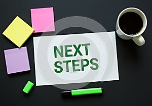 next steps planning workspace with notes coffee and marker