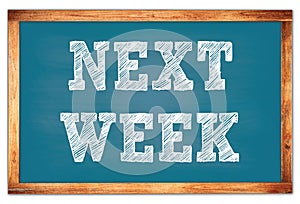 NEXT WEEK words on blue wooden frame school blackboard